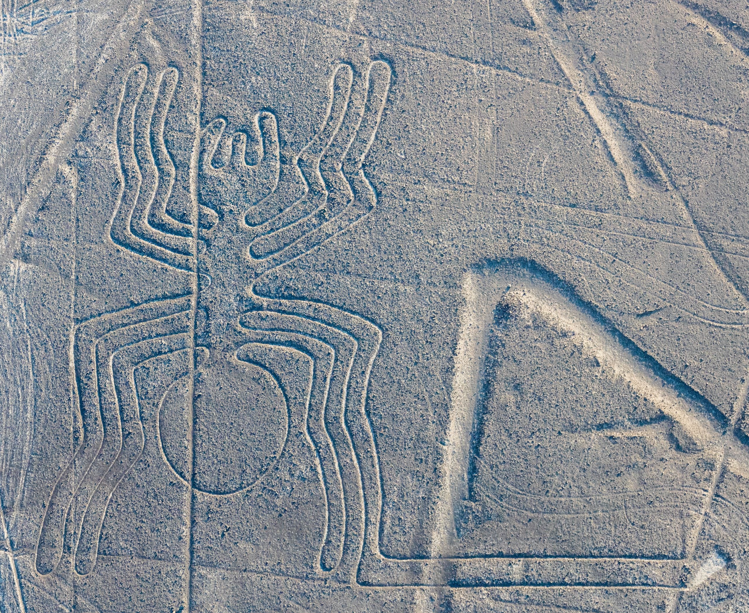 Aerial view of the Nazca Lines spider geoglyph etched into the desert floor.
