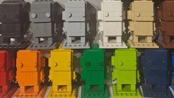 A grid of twelve blocky, robot-like figures built from LEGO bricks in a variety of solid colors.