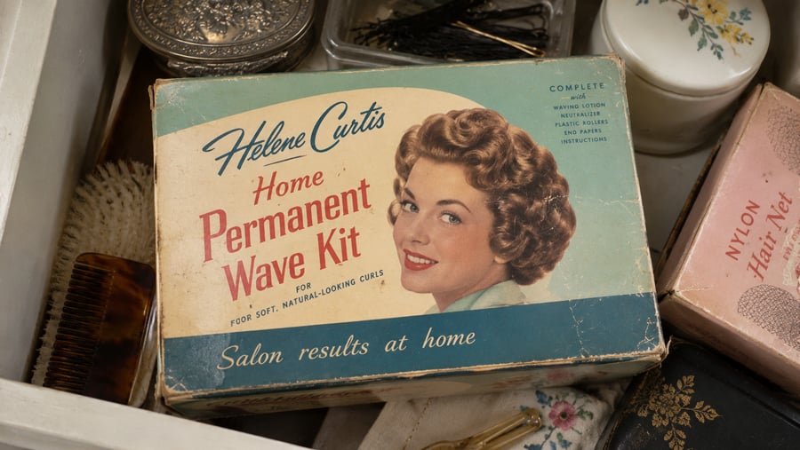 Vintage Helene Curtis Home Permanent Wave Kit box in a drawer with other grooming supplies.