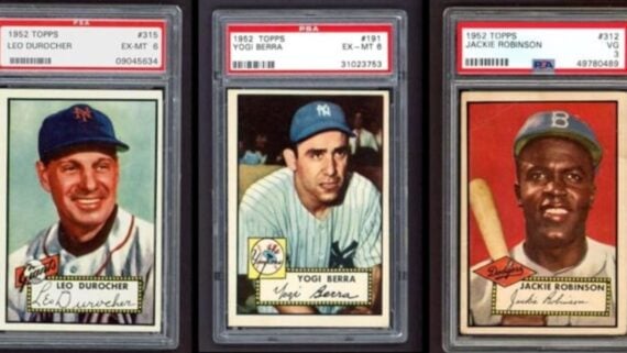 Three 1952 Topps baseball cards of Leo Durocher, Yogi Berra, and Jackie Robinson, each encased in a PSA protective slab.
