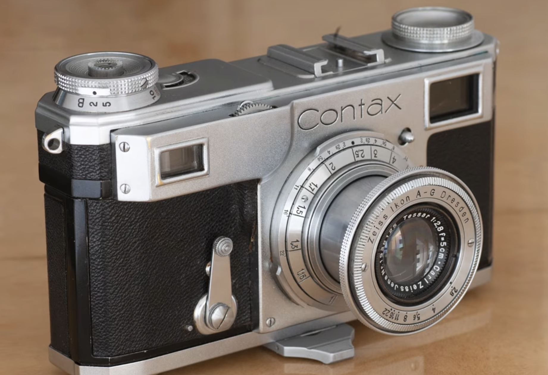 A vintage silver Contax rangefinder camera with a Zeiss Ikon lens.