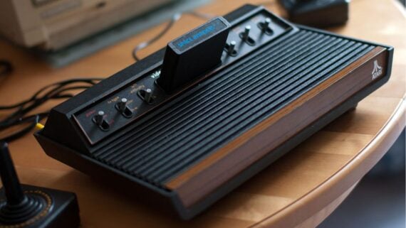 Atari 2600 game console with a Space Invaders game cartridge inserted.