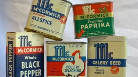 Five vintage McCormick spice tins, including allspice, paprika, black pepper, poultry seasoning, and celery seed.