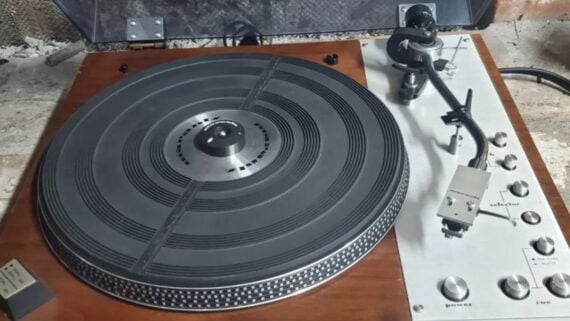 A vintage Marantz turntable with a wooden base and silver control panel.